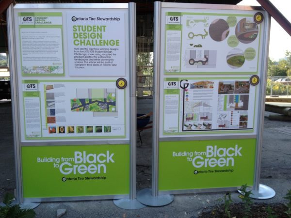 Signs promoting the top three designs submitted in the Student Design Challenge at Evergreen Brick Works. The winning design is on the left.