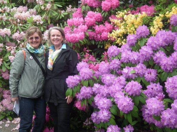 Lorraine Flanigan (left) with Garden Director Liz Klose in front of the magnificent display of rhododendrons.