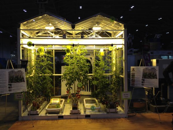 This display of a working greenhouse includes everything needed to grow tomatoes year round, including live bees.
