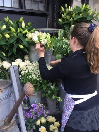 Making sure every bloom looks perfect in front of the store.