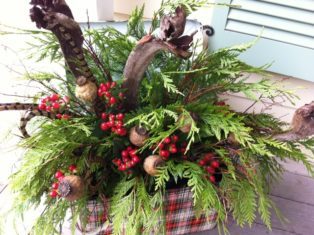 Beautiful holiday container with berries, greens, pods and curly branches. (Garden Making photo)